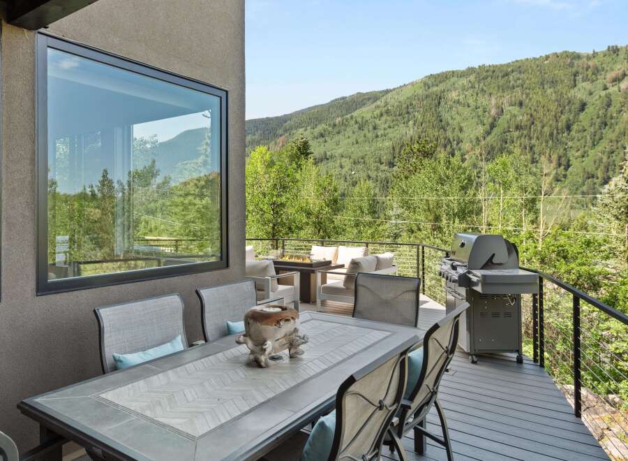 Enjoy breathtaking mountain views from this stunning deck, perfect for outdoor dining and entertaining.