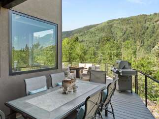 Enjoy breathtaking mountain views from this stunning deck, perfect for outdoor dining and entertaining.