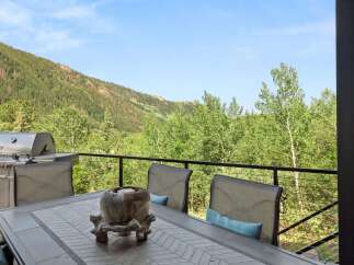 Enjoy breathtaking mountain views from this stunning deck, perfect for outdoor dining and entertaining.