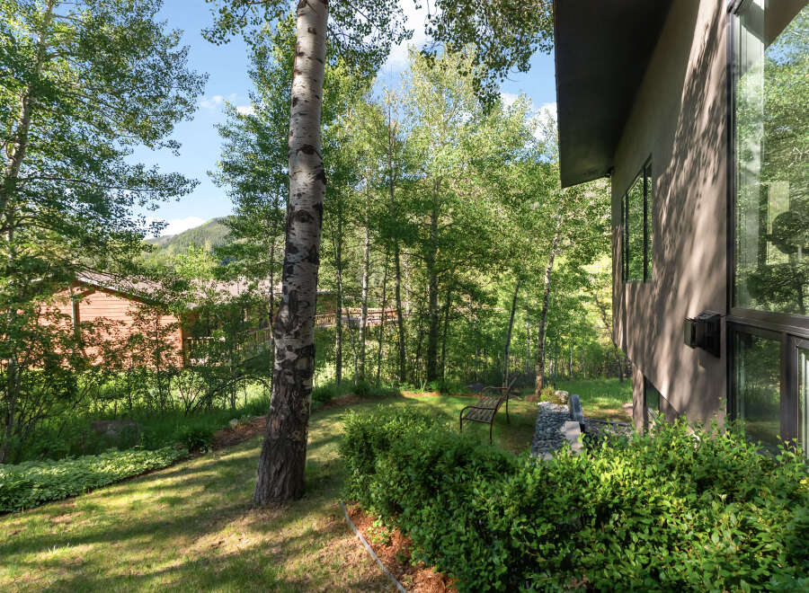 Experience serene living in this stunning property nestled amidst lush greenery and mature trees.
