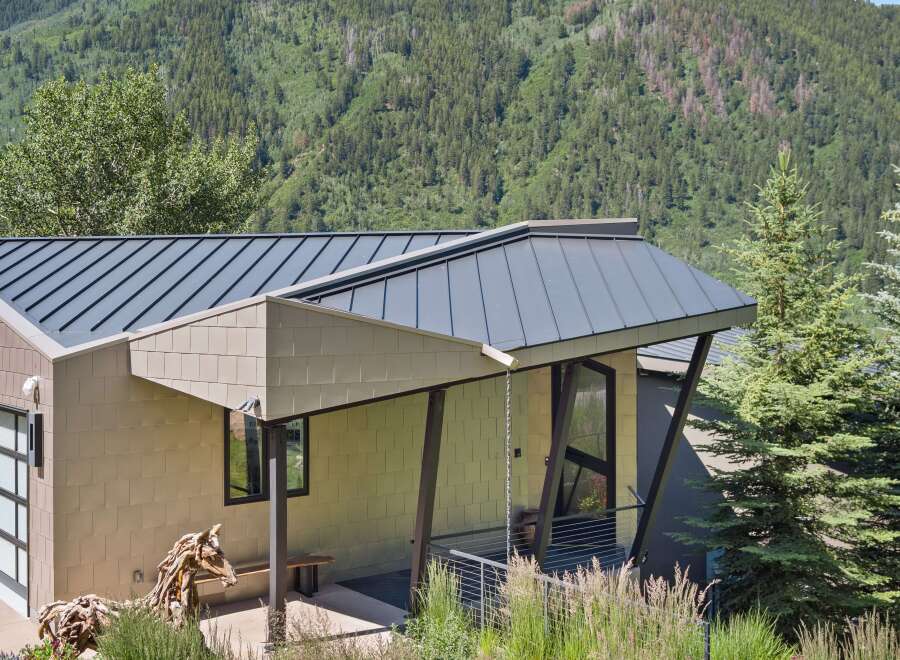 Experience modern mountain living in this stunning home, featuring a sleek metal roof and unique architectural design.