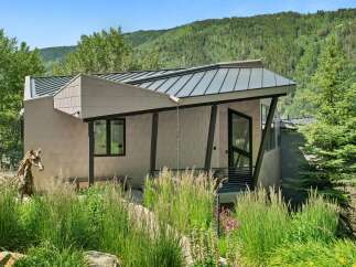 Experience modern mountain living in this architecturally stunning home, featuring a unique metal facade and a dynamic roofline that complements the natural landscape.