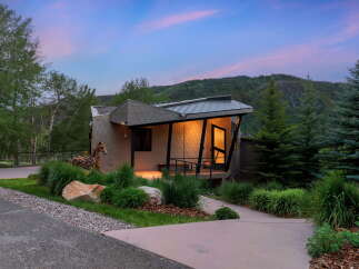 Experience modern mountain living in this stunning architectural home, nestled amidst lush greenery and majestic trees.