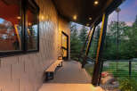Experience modern living with this stunning property featuring a sleek exterior and a spacious covered porch.