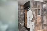 Experience ultimate relaxation in this luxurious bathroom featuring a private sauna and a spacious glass-enclosed shower.