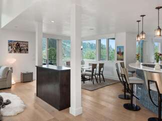 Experience modern living in this open-concept space featuring a sleek kitchen island with bar seating and a separate dining area.