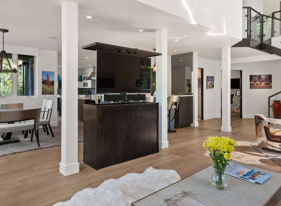 Experience modern living in this spacious open-concept home, featuring a retractable TV for seamless entertainment.
