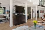 Experience modern living in this spacious open-concept home, featuring a retractable TV for seamless entertainment.