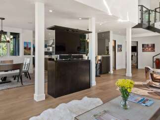 Experience modern living in this spacious open-concept home, featuring a retractable TV for seamless entertainment.
