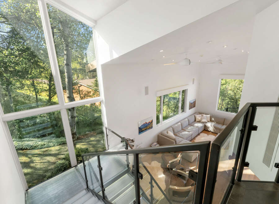 Experience modern luxury in this stunning home featuring soaring ceilings and expansive windows that flood the space with natural light.