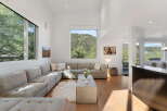 Experience breathtaking mountain views from this stunning living room, featuring a large sectional sofa perfect for relaxation.