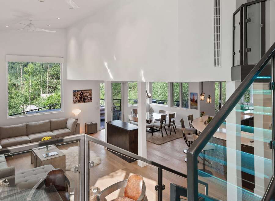 Experience luxury living in this stunning modern home featuring an open-concept living space with soaring ceilings and abundant natural light.
