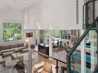 Experience luxury living in this stunning modern home featuring an open-concept living space with soaring ceilings and abundant natural light.