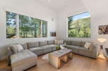 Experience breathtaking mountain views from this stunning living room, featuring a spacious sectional sofa perfect for relaxation.