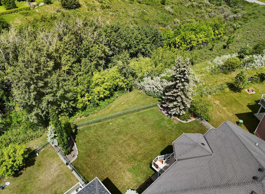 Discover this stunning property featuring a spacious backyard with lush green grass, perfect for outdoor activities and relaxation.