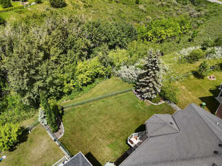 Discover this stunning property featuring a spacious backyard with lush green grass, perfect for outdoor activities and relaxation.