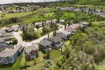 Discover this stunning suburban neighborhood featuring a collection of beautiful, modern homes nestled amidst lush greenery and rolling hills.