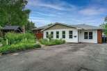 Discover this charming property featuring a welcoming exterior with a mix of brick and white siding.