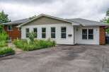 Charming single-family home featuring a welcoming facade with white siding and brick accents.