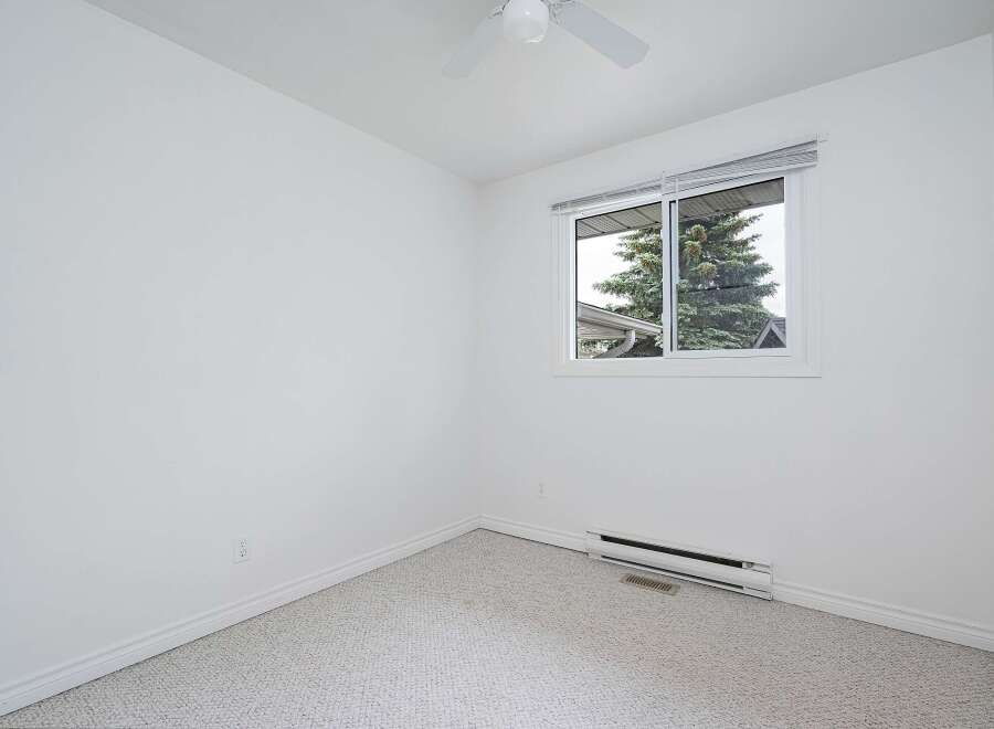 This bright and airy bedroom features a neutral color palette, making it a versatile canvas for any decor style.
