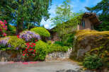 Nestled amidst lush greenery and vibrant blooms, this charming home offers a serene retreat.