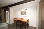 This dining area features a charming wooden table with four chairs, perfect for intimate meals.