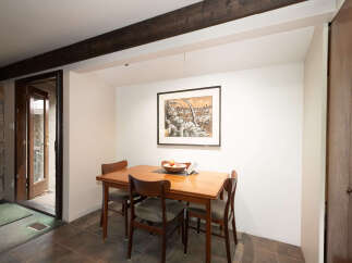 This dining area features a charming wooden table with four chairs, perfect for intimate meals.