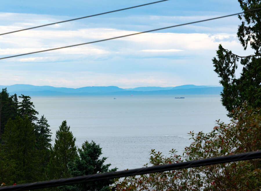 Experience breathtaking ocean views from this stunning property, offering a serene escape with distant islands and tranquil waters.