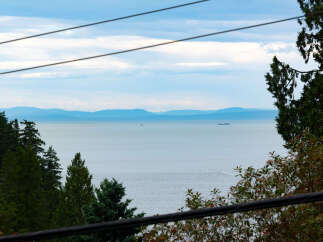 Experience breathtaking ocean views from this stunning property, offering a serene escape with distant islands and tranquil waters.