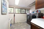 This laundry room features a spacious layout with a large capacity washer and dryer set, perfect for handling family-sized loads.