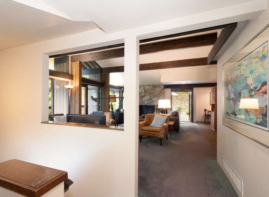 Step into this inviting living space featuring a cozy stone fireplace and comfortable seating.