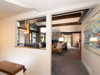 Step into this inviting living space featuring a cozy stone fireplace and comfortable seating.