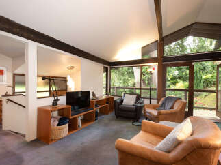 Experience the perfect blend of comfort and style in this inviting living room, featuring plush leather armchairs and a cozy seating area.