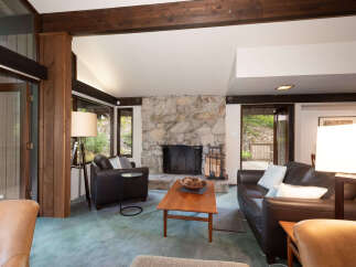 Experience rustic charm in this inviting living room, featuring a magnificent stone fireplace as the centerpiece.
