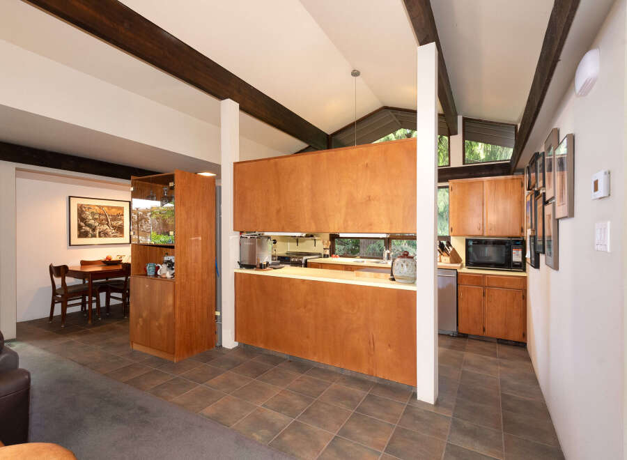 Discover this stunning home featuring a modern kitchen with rich wood cabinetry and sleek countertops, perfect for culinary enthusiasts.