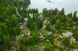 Discover this stunning aerial view of a lush, green neighborhood nestled beside a serene body of water.