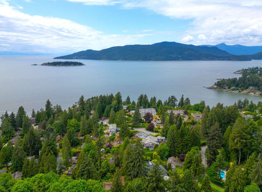 Discover luxurious living nestled amidst lush greenery with stunning water views.