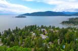Discover luxurious living nestled amidst lush greenery with stunning water views.
