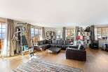 Experience ultimate relaxation and fitness in this spacious living area, featuring a comprehensive home gym setup.