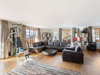 Experience ultimate relaxation and fitness in this spacious living area, featuring a comprehensive home gym setup.