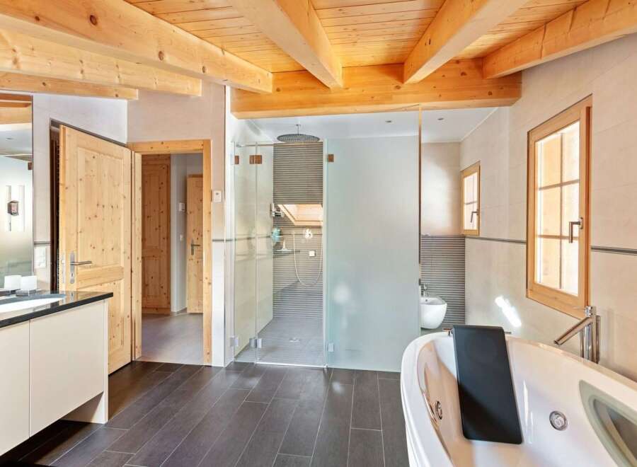 Experience luxury in this stunning bathroom featuring a spacious jacuzzi tub and a separate glass-enclosed shower.