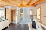 Experience luxury in this stunning bathroom featuring a spacious jacuzzi tub and a separate glass-enclosed shower.