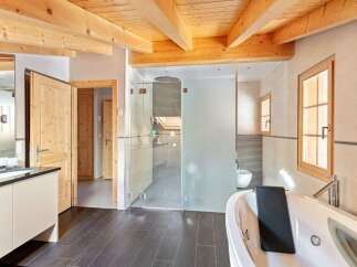 Experience luxury in this stunning bathroom featuring a spacious jacuzzi tub and a separate glass-enclosed shower.