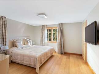 This charming bedroom features a comfortable queen-sized bed with plush pillows and a quilted comforter, perfect for a restful night's sleep.
