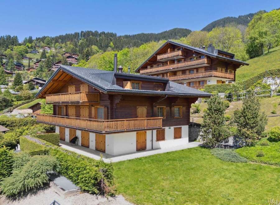 Experience luxurious alpine living in this stunning wooden chalet, nestled amidst rolling green hills and picturesque mountain scenery.