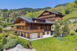 Experience luxurious alpine living in this stunning wooden chalet, nestled amidst rolling green hills and picturesque mountain scenery.