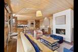 Experience luxurious mountain living in this stunning open-concept living space, featuring a cozy fireplace and a fully equipped kitchen perfect for entertaining.
