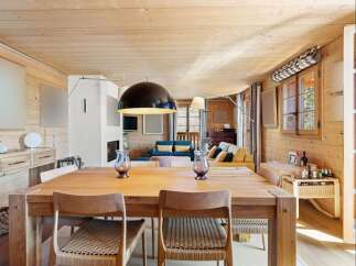 Experience rustic charm and modern comfort in this inviting dining and living space.