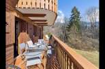Enjoy breathtaking mountain views from this charming wooden balcony, perfect for al fresco dining or morning coffee.