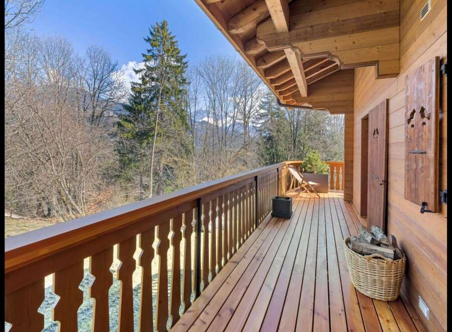 Experience the charm of this rustic wooden balcony, offering stunning views of the surrounding natural landscape.